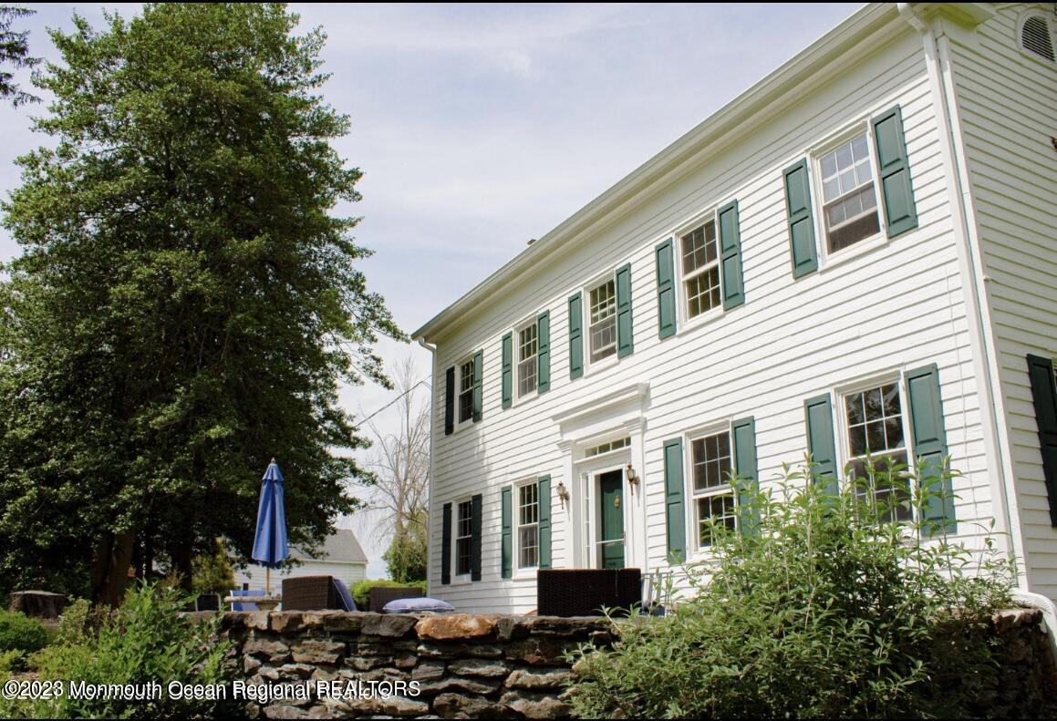 415 Pleasant Valley Road Morganville, NJ 07751 - Photo 3 of 16 a front view of a house with lots of green space