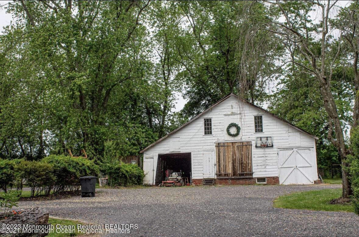 415 Pleasant Valley Road Morganville, NJ 07751 - Photo 5 of 16 a view of a house with a yard and large trees