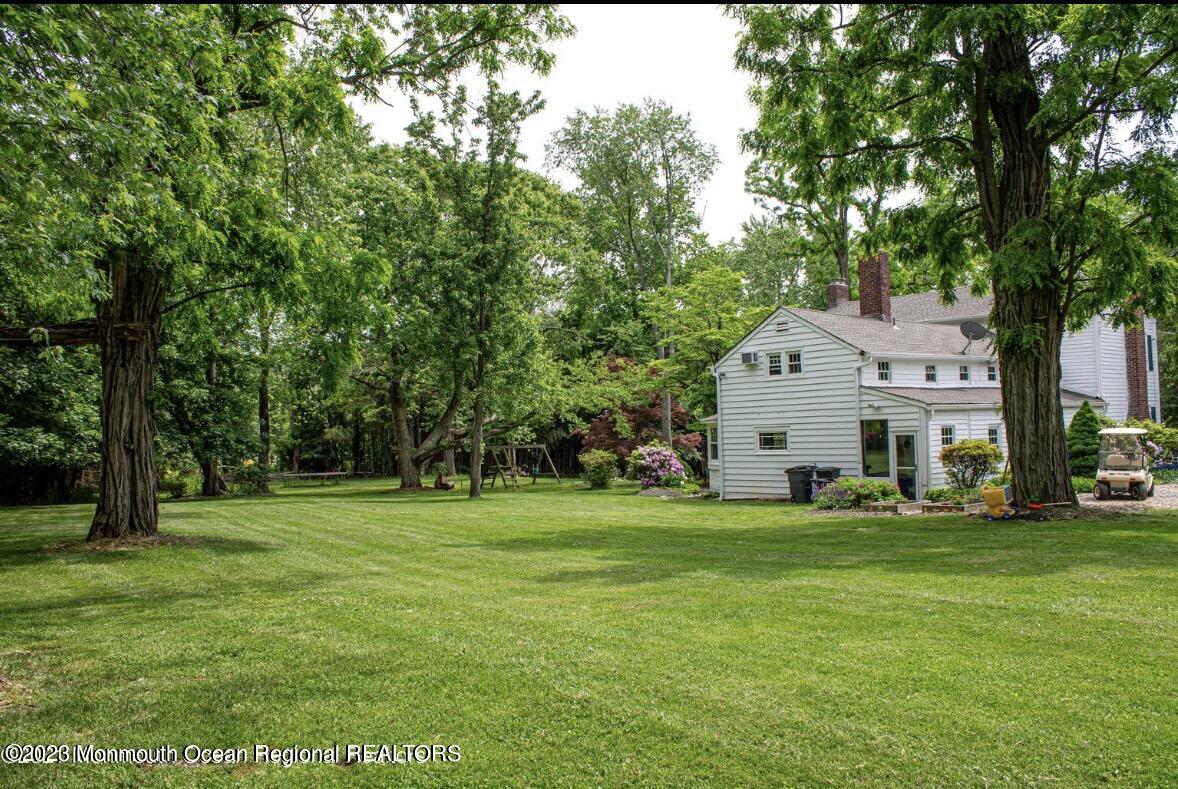 415 Pleasant Valley Road Morganville, NJ 07751 - Photo 8 of 16 a view of a house with a big yard