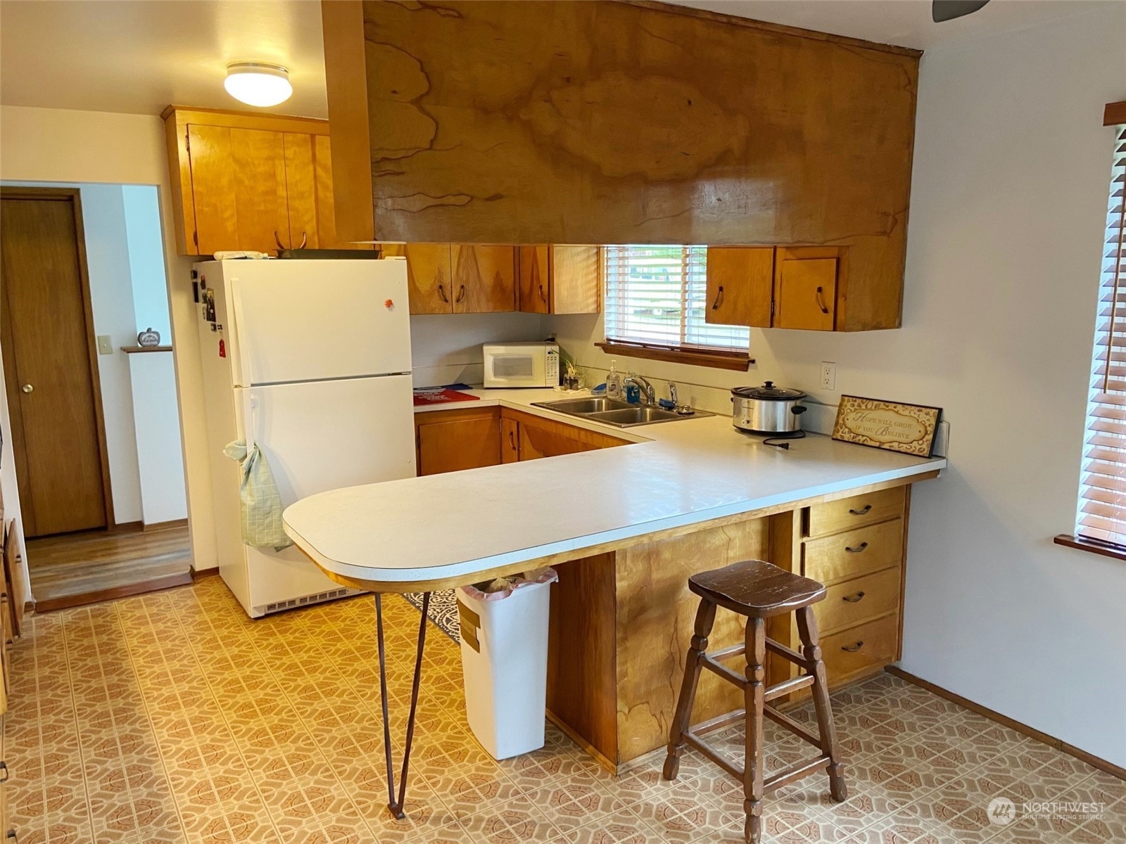 12733 2nd Avenue Southwest Burien, WA 98146 - Photo 3 of 27 a dining room with a table chairs and a refrigerator