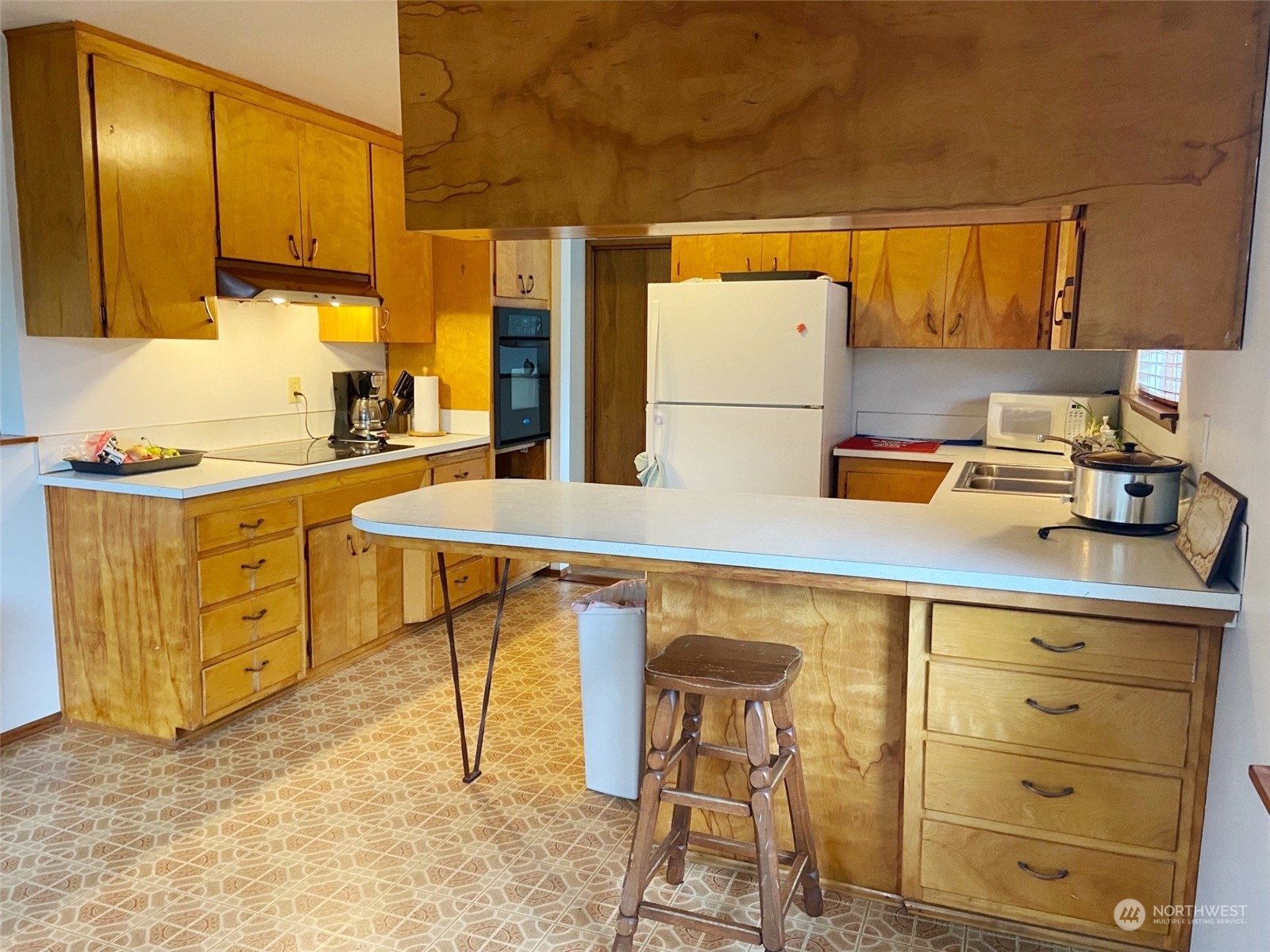 12733 2nd Avenue Southwest Burien, WA 98146 - Photo 4 of 27 a kitchen with a sink a stove cabinets and a dining table