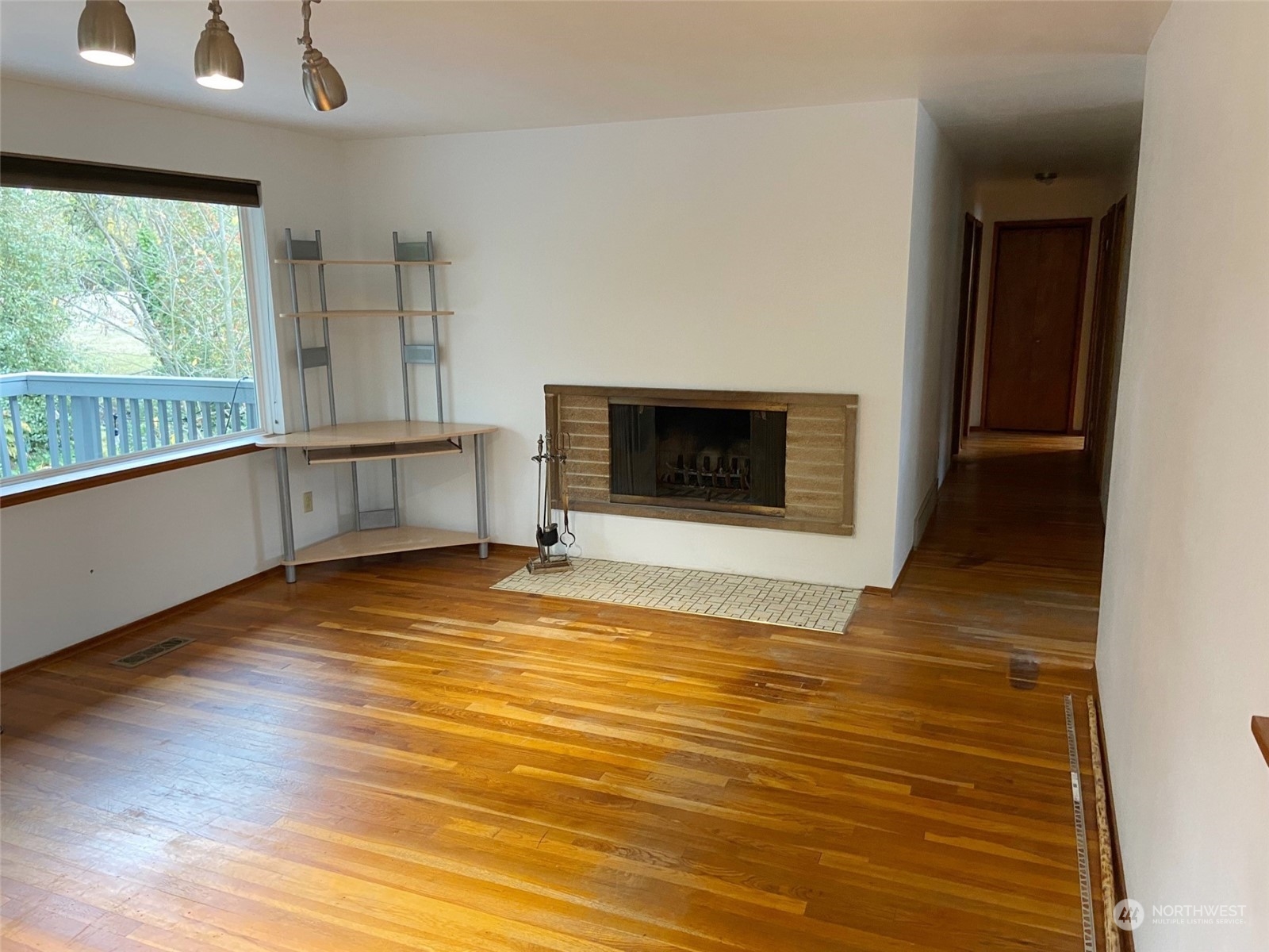 12733 2nd Avenue Southwest Burien, WA 98146 - Photo 7 of 27 a view of empty room with wooden floor and fireplace
