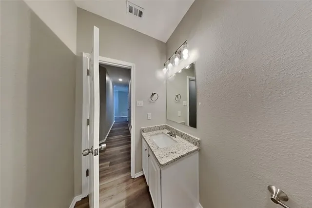 a view of a bathroom with a sink and mirror