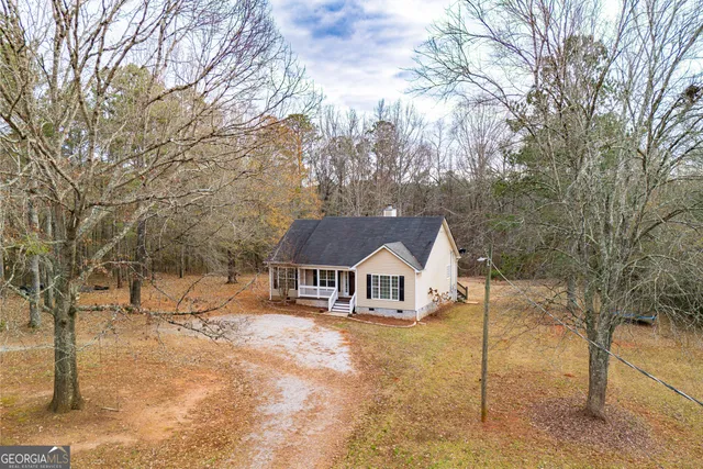a view of house with a yard