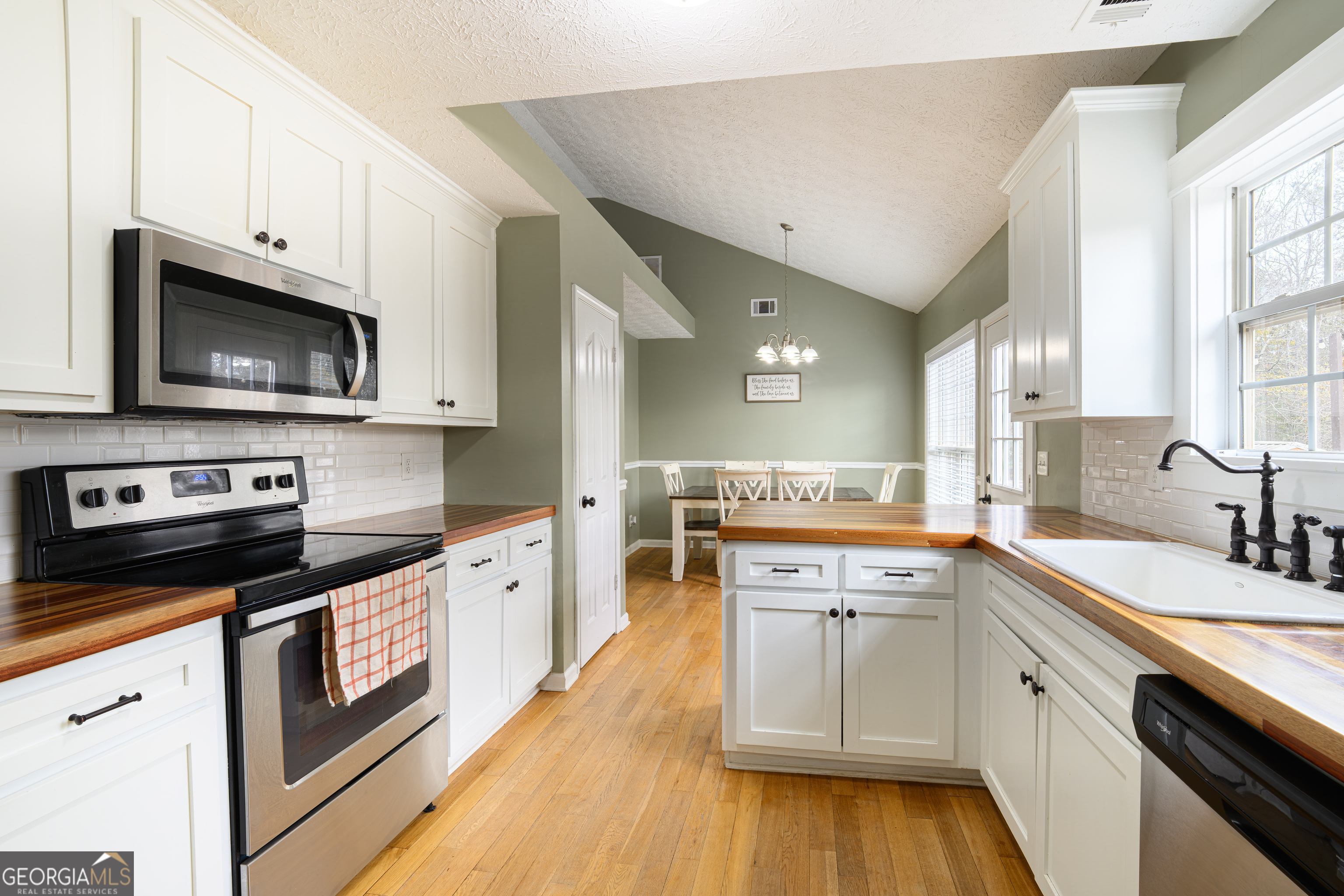171 Hunter Road Griffin, GA 30224 - Photo 18 of 31 a kitchen with stainless steel appliances granite countertop a sink and stove top oven