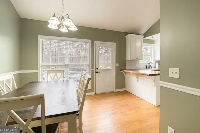 a very nice looking dining room with a large window