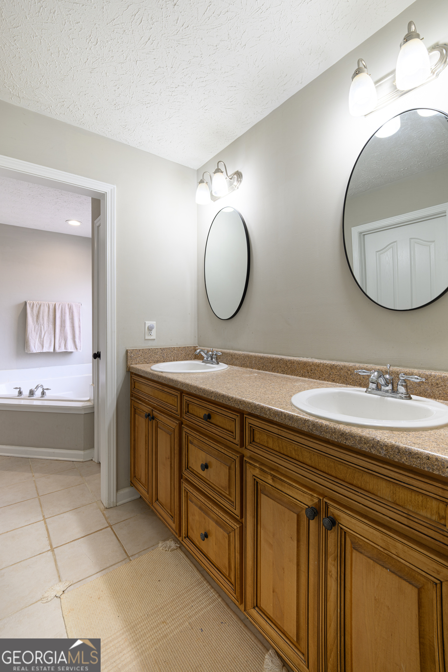 171 Hunter Road Griffin, GA 30224 - Photo 22 of 31 a bathroom with a double vanity sink mirror and a bathtub