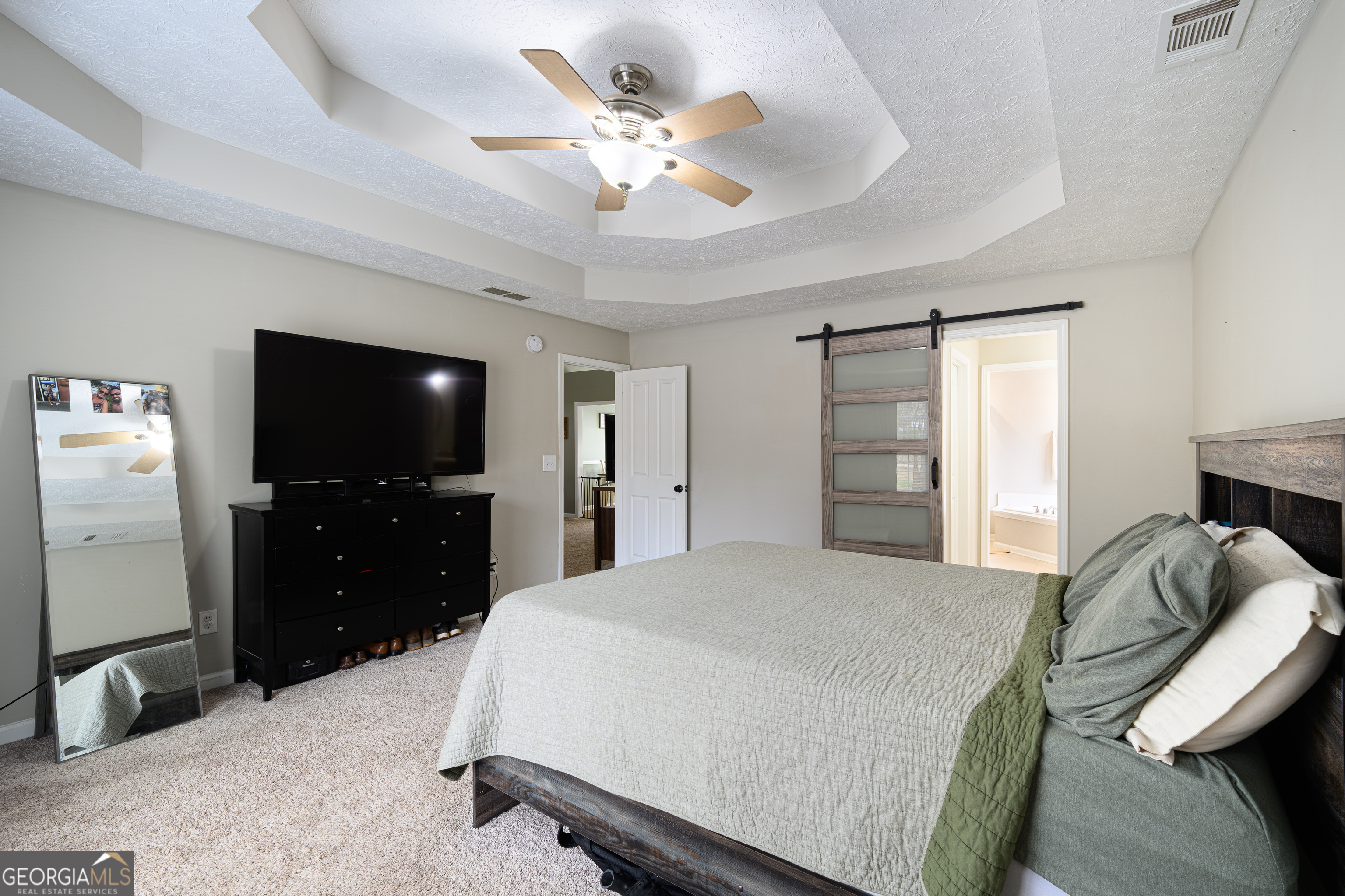 171 Hunter Road Griffin, GA 30224 - Photo 23 of 31 a bedroom with a bed and a flat screen tv