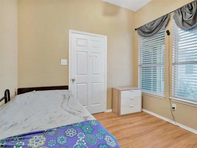 a bedroom with a bed and a window