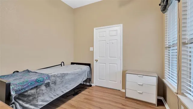 a bedroom with a bed and a dresser