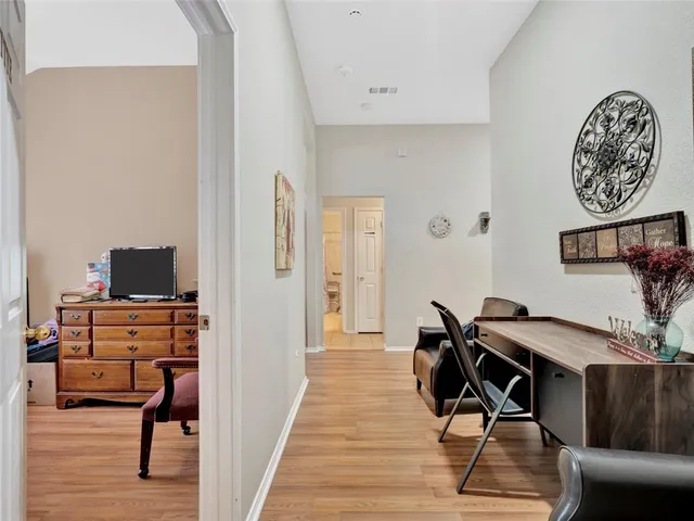 a view of a workspace with furniture and wooden floor