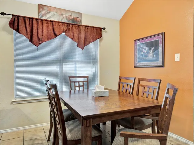 a dining room with furniture and window