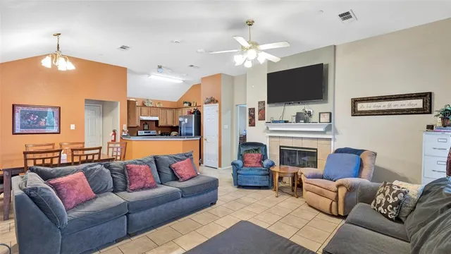 a living room with furniture a flat screen tv and a large window