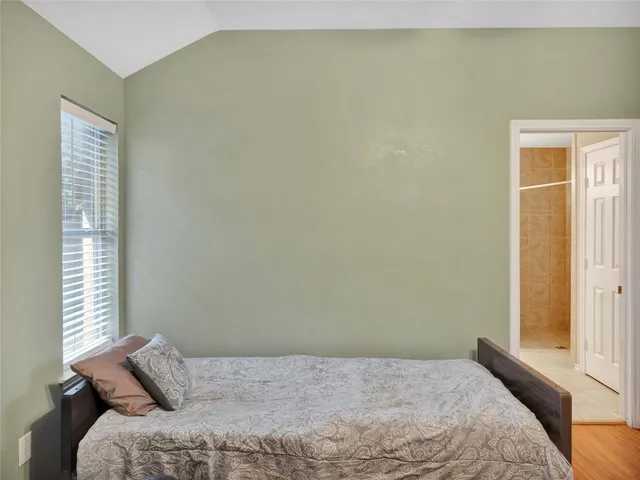 a bedroom with furniture and a window