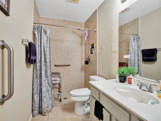 a bathroom with a sink toilet a mirror and shower