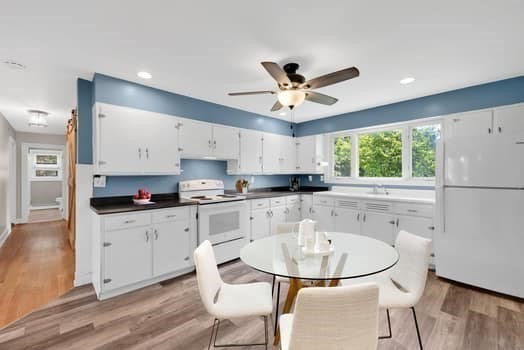 61 East Longmeadow Road Hampden, MA 01036 - Photo 17 of 38 a kitchen with stainless steel appliances granite countertop a sink a stove a refrigerator with white cabinets and wooden floor