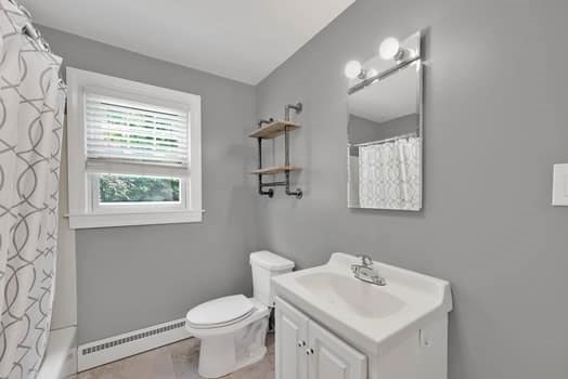 61 East Longmeadow Road Hampden, MA 01036 - Photo 26 of 38 a bathroom with a toilet sink and mirror