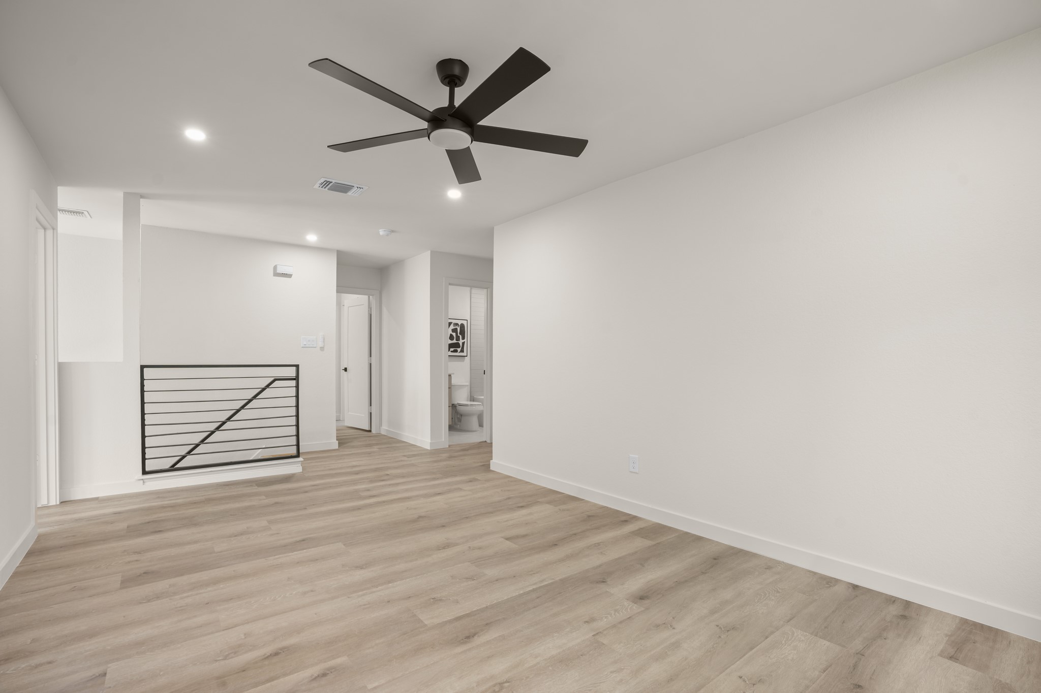 7826 Wheel Rim Circle Austin, TX 78749 - Photo 20 of 38 Smooth wood-look flooring and clean lines define this versatile upper-level living space.