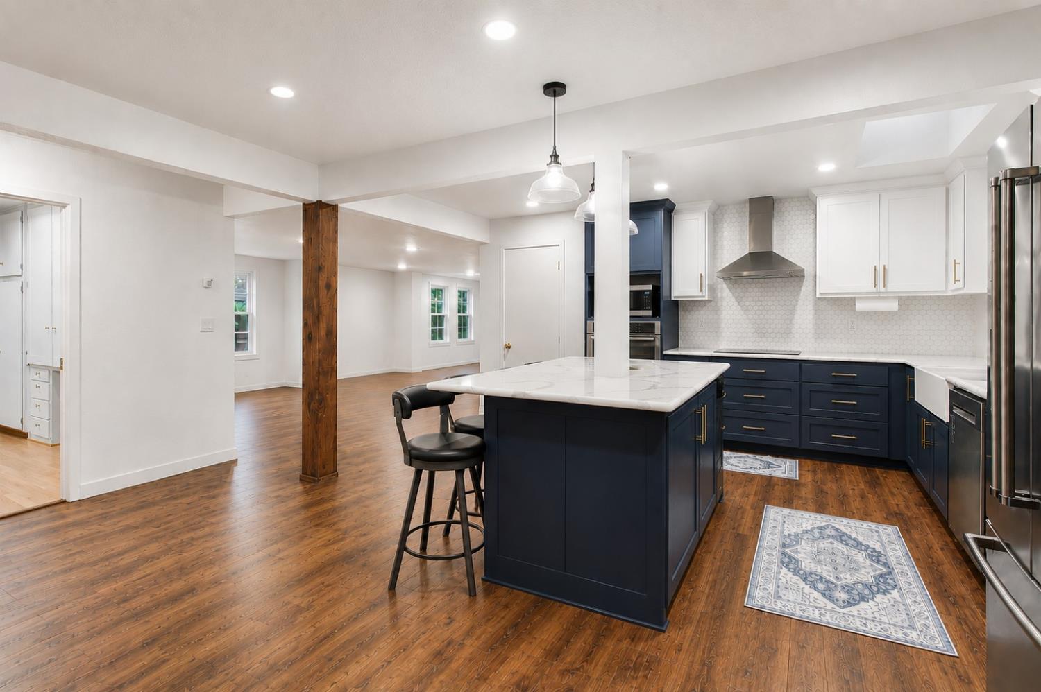 1908 Chelwood Way Modesto, CA 95355 - Photo 6 of 32 a kitchen with stainless steel appliances granite countertop a stove a sink a refrigerator and a dining table with wooden floor