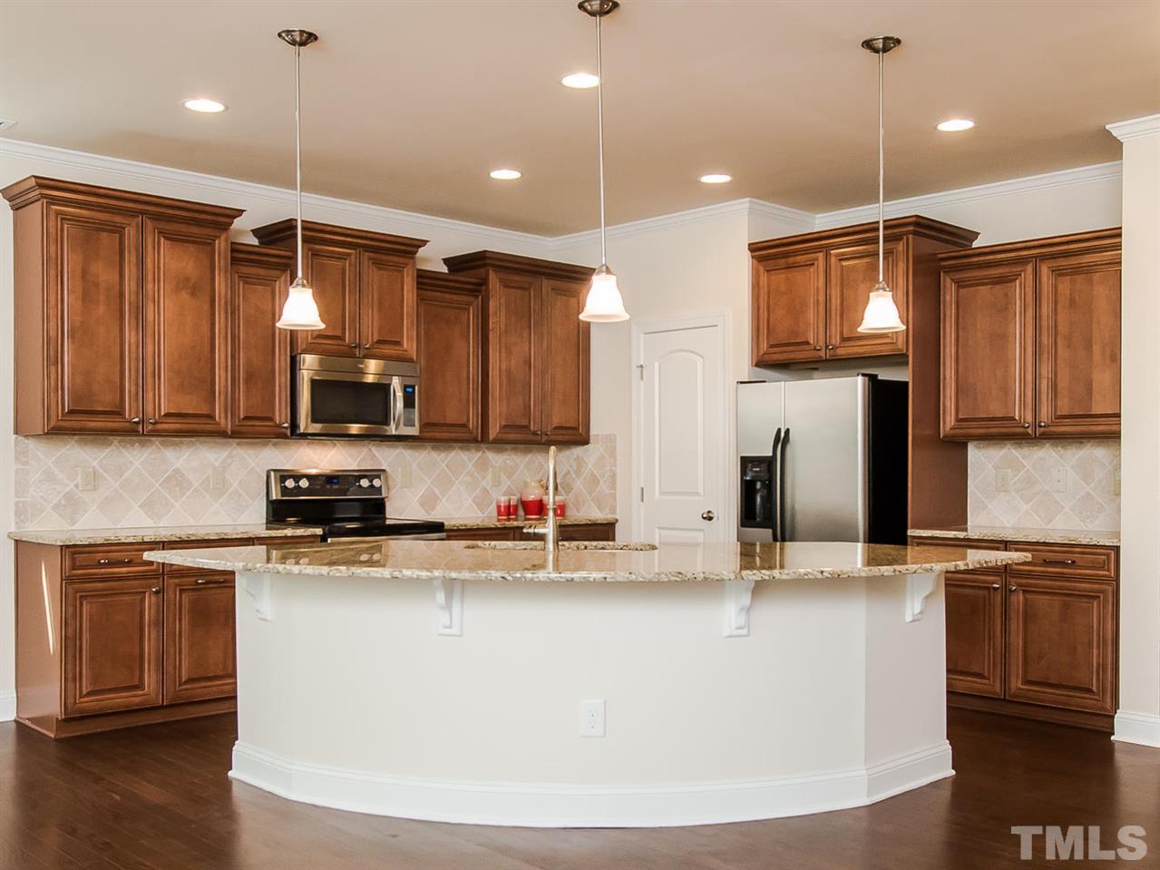 6508 Ridgemount Street Wake Forest, NC 27587 - Photo 1 of 24 Can you believe the size of this granite island? So much fun can happen here. Conversations! Meal prep! Projects!!! It can easily have 4-5 chairs placed around it.