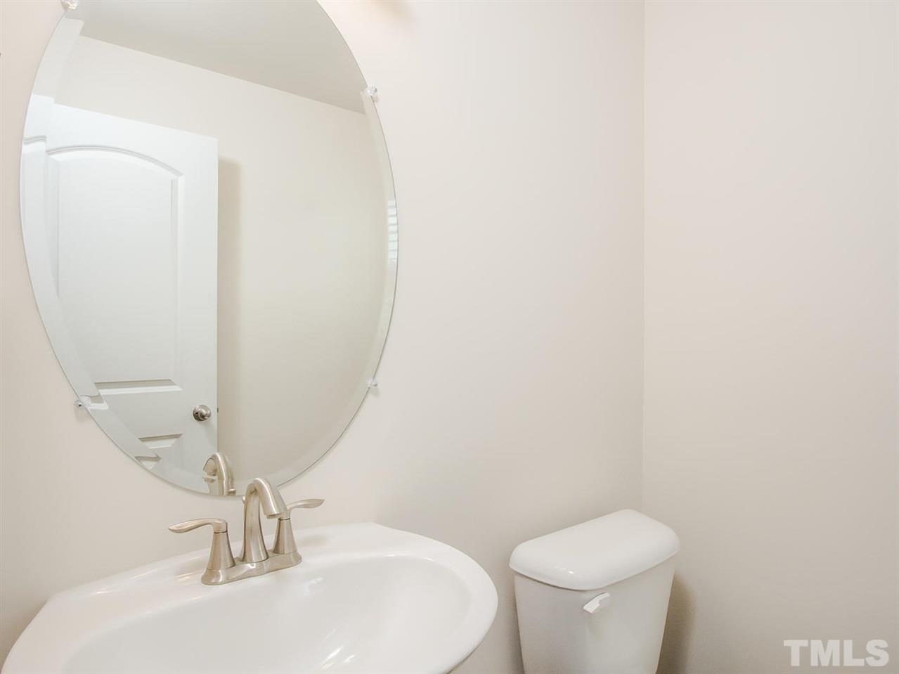 6508 Ridgemount Street Wake Forest, NC 27587 - Photo 16 of 24 Half bath at 6508 Ridgemount is located near the stairway and has a window.