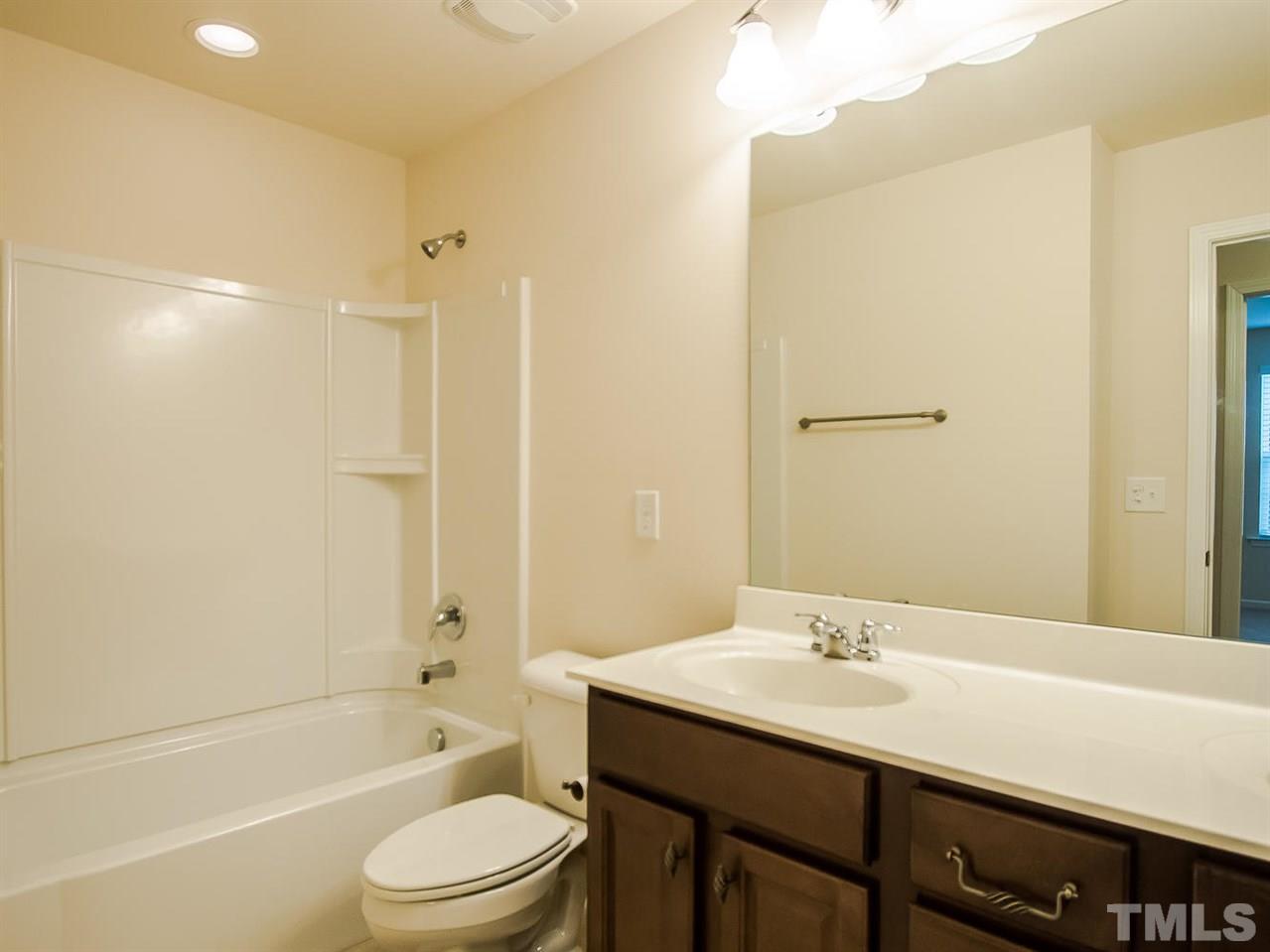 6508 Ridgemount Street Wake Forest, NC 27587 - Photo 18 of 24 Second floor bathroom with large tub/shower and vanity. Located nearby is a linen closet.