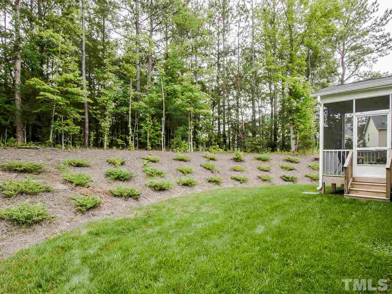 6508 Ridgemount Street Wake Forest, NC 27587 - Photo 21 of 24 The backyard of 6508 Ridgemount is wonderfully landscaped and partially wooded for privacy.