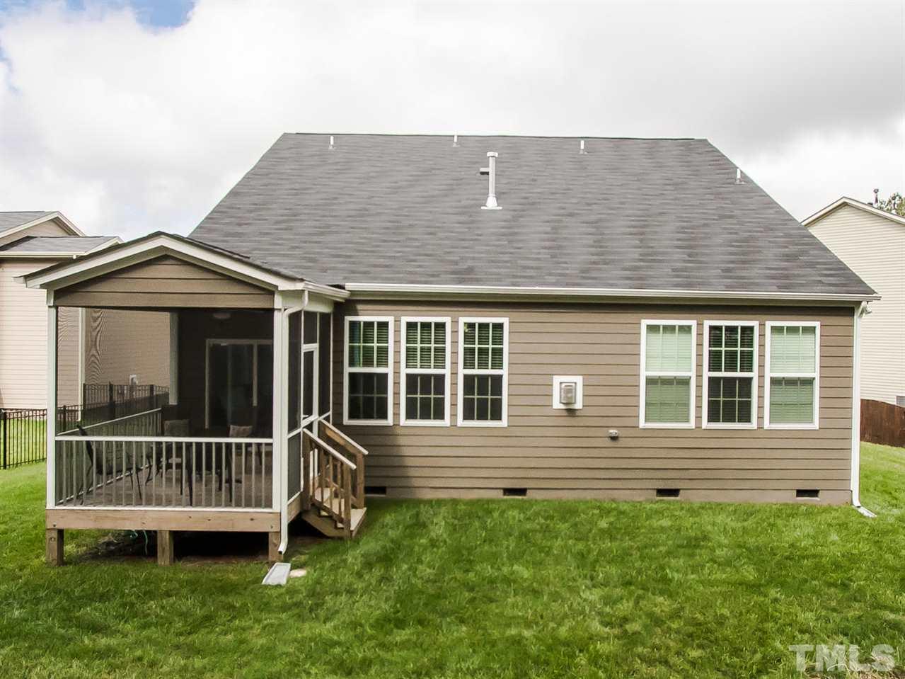 6508 Ridgemount Street Wake Forest, NC 27587 - Photo 22 of 24 The back of 6508 Ridgemount shows a nice green back yard and an easy access to the screened porch.