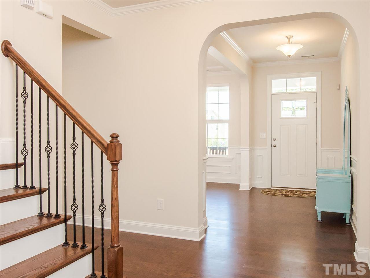 6508 Ridgemount Street Wake Forest, NC 27587 - Photo 9 of 24 Elegant arches located in the foyer at 6508 Ridgemount. Located close is the half bath and laundry room. Stairs lead to second floor.