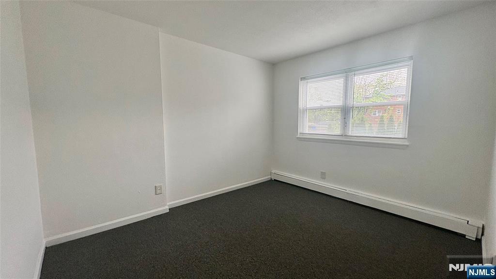 299 Main Street, Unit 7 Lodi, NJ 07644 - Photo 11 of 14 an empty room with a window