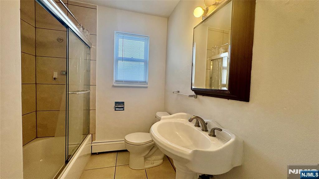 299 Main Street, Unit 7 Lodi, NJ 07644 - Photo 13 of 14 a bathroom with a sink and a toilet
