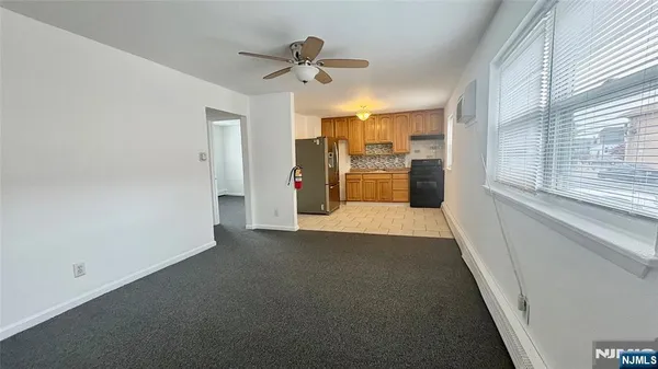 a view of a room with a kitchen