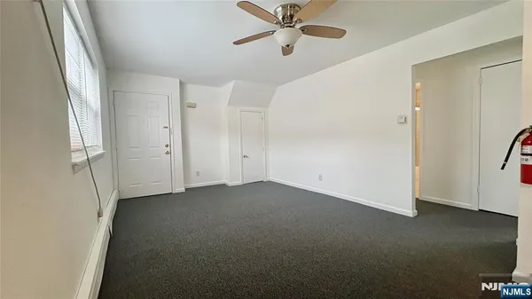a view of empty room with ceiling fan