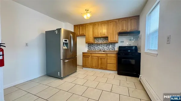 a kitchen with stainless steel appliances a refrigerator sink and cabinets