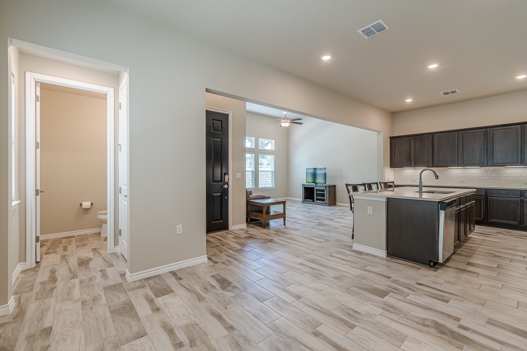 108 Lafitte Drive, Unit 102 San Marcos, TX 78666 - Photo 26 of 27 Kitchen with open floor plan, light wood-style floors, light countertops, a center island with sink, and recessed lighting