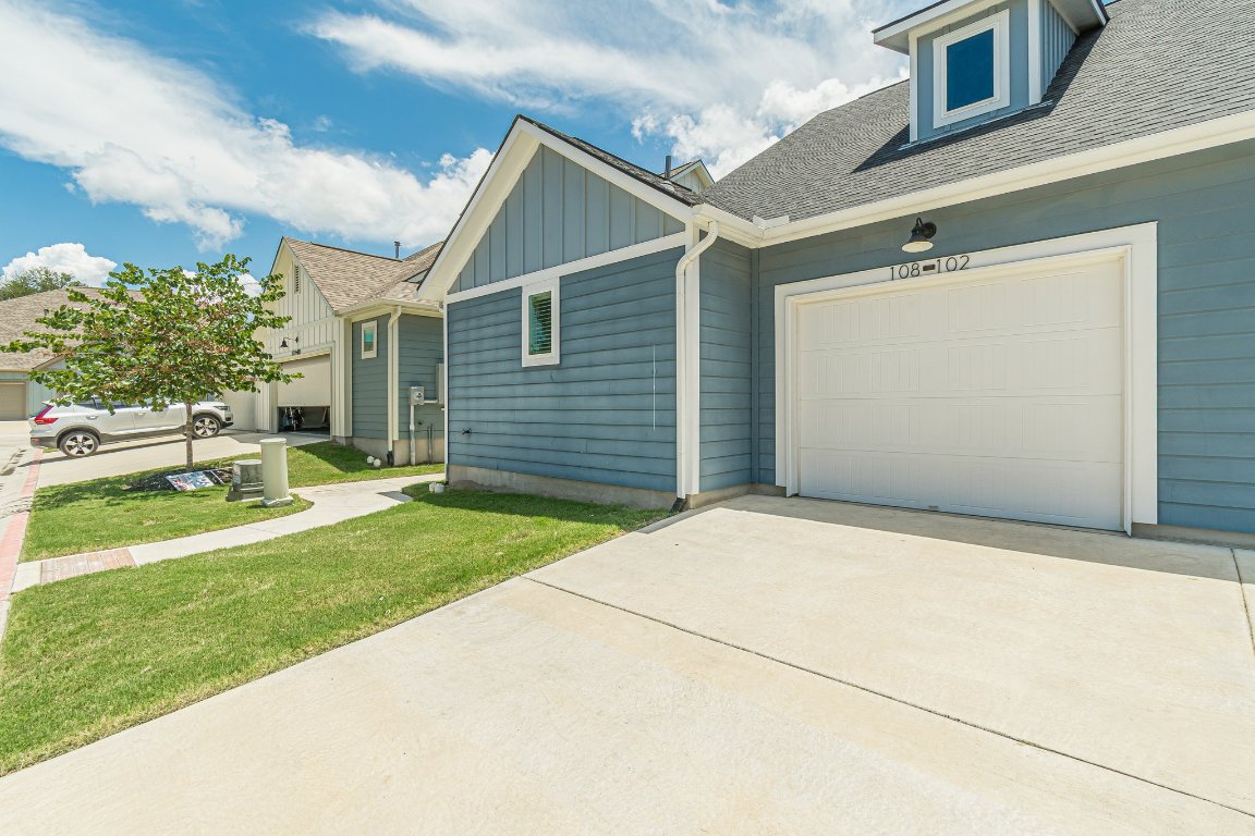 1330 Wonder World Drive, Unit 102 San Marcos, TX 78666 - Photo 24 of 27 a front view of a house with a yard