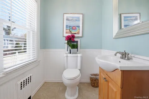 a bathroom with a sink mirror vanity and toilet