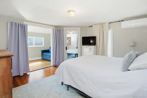 a bedroom with a large bed and a tv