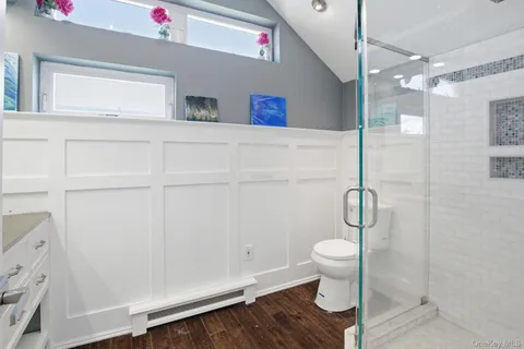 a bathroom with a shower and a toilet
