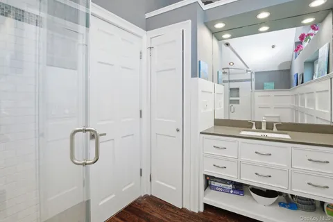 a bathroom with a shower sink and mirror
