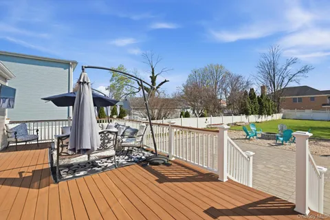 a view of a deck with chairs and wooden floor
