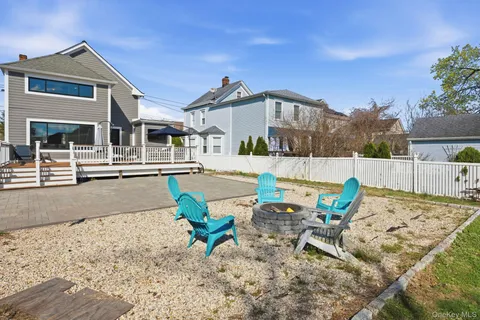 a view of a house with backyard and sitting area