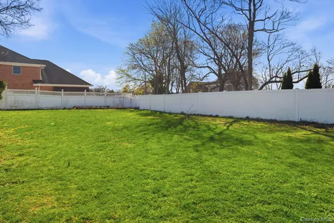 a view of an house with backyard space and balcony