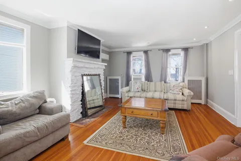 a living room with fireplace furniture and a rug