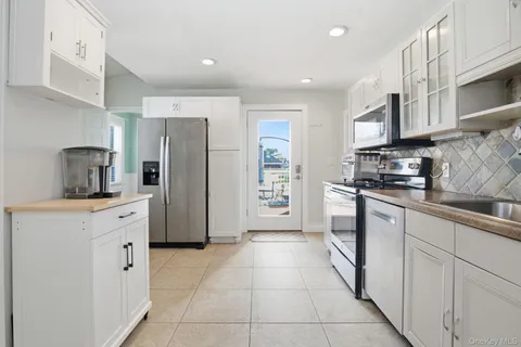 a kitchen with stainless steel appliances a refrigerator sink and cabinets