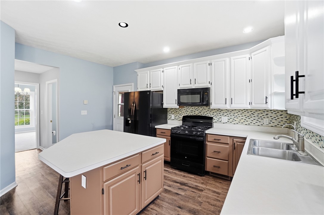 10 Chase Court Springboro, OH 45066 - Photo 22 of 75 This bright kitchen features ample counter space, a central island, and modern appliances perfect for daily living.