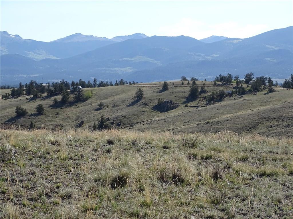 415 Arland Road Como, CO 80432 - Photo 17 of 19 a view of a dry field with mountains in the background