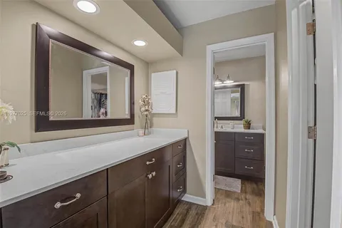 a spacious bathroom with a sink and mirror