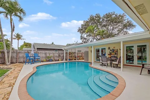 swimming pool view with plants and seating space
