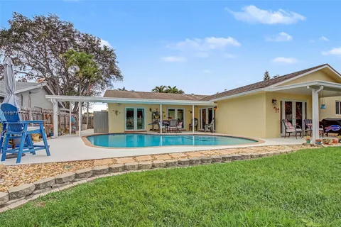 a front view of a house with a yard table and chairs